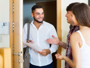 Door to door salesman talking to clients