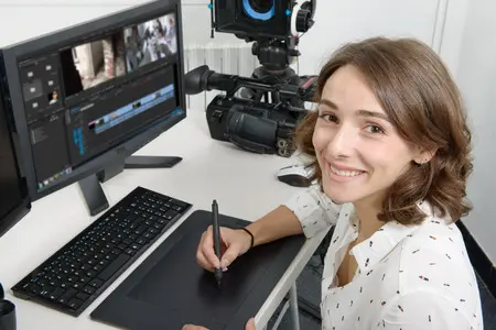 67141376 - young woman designer using graphics tablet for video editing